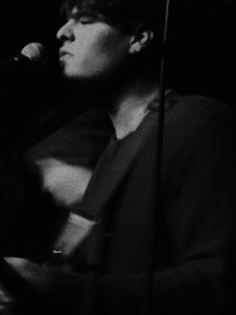 Black and white close-up of Ben singing with his eyes closed