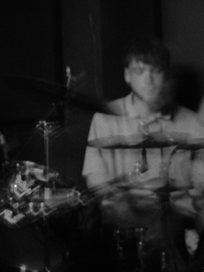 Jake Clements playing drums, black and white