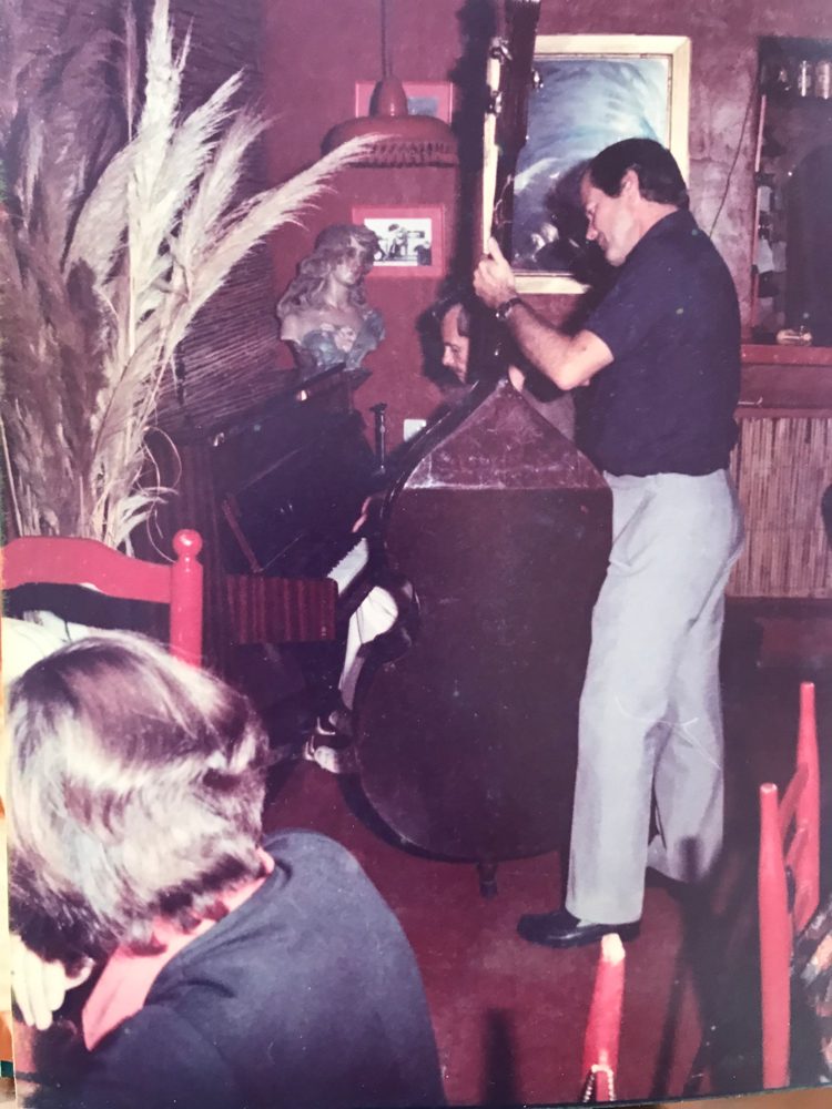 Dennis Boas playing the upright piano at Scandals in the 1970s, with a double bass player beside him